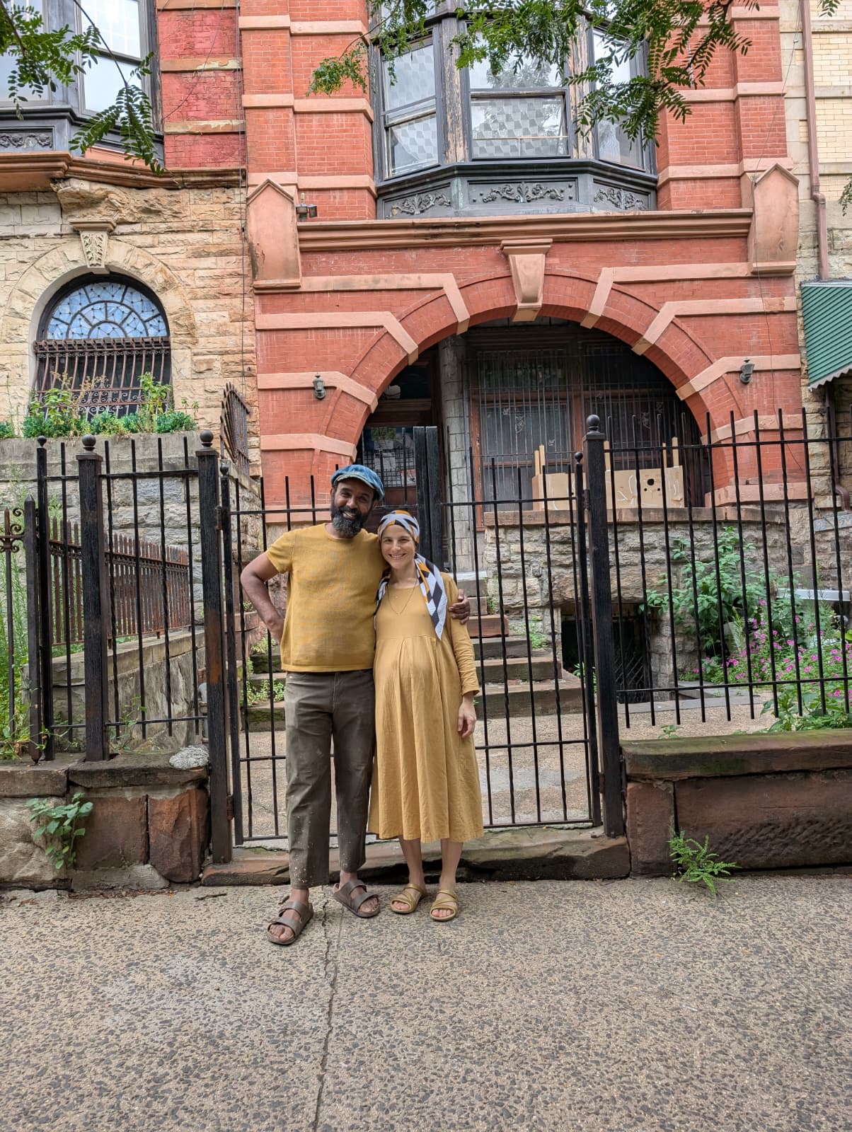 Mordechai and Daniella standing outside the brownstone building